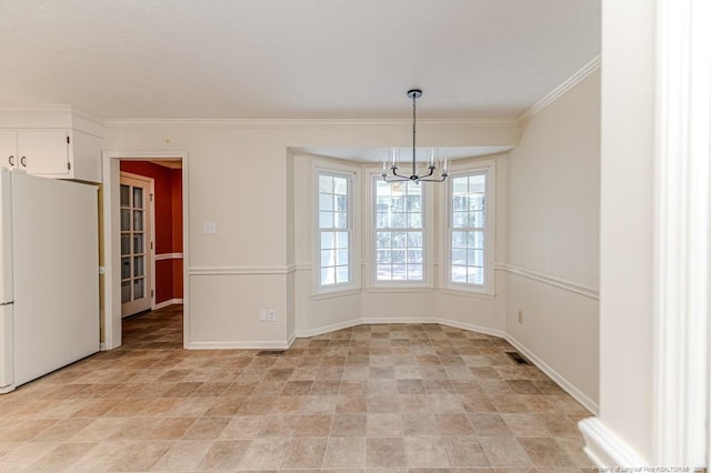 unfurnished dining area with visible vents, baseboards, a notable chandelier, and ornamental molding