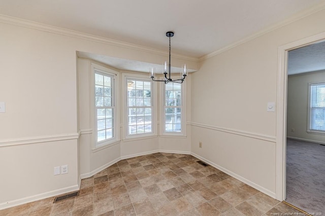 unfurnished dining area with crown molding, a notable chandelier, and visible vents