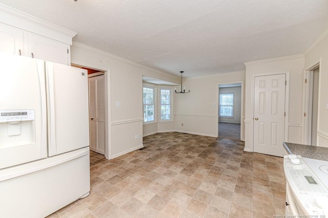 kitchen featuring white cabinets, white refrigerator with ice dispenser, crown molding, decorative light fixtures, and a notable chandelier