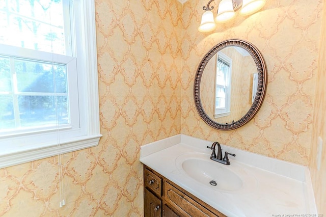 bathroom with wallpapered walls and vanity