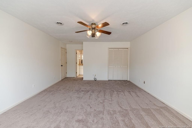 unfurnished bedroom with a closet, visible vents, baseboards, and carpet