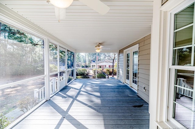 wooden terrace featuring covered porch and ceiling fan