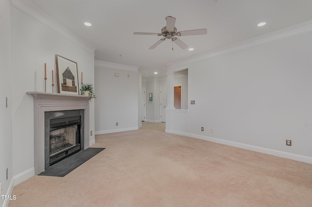 unfurnished living room featuring a fireplace with flush hearth, a ceiling fan, crown molding, baseboards, and light colored carpet