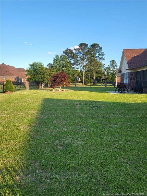 view of yard featuring a patio and fence