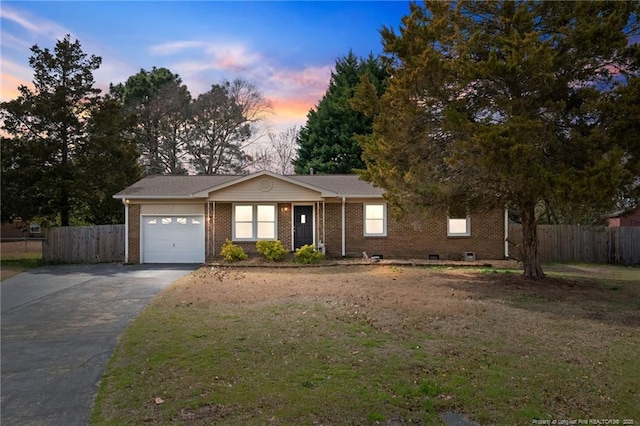 ranch-style home featuring fence, a yard, a garage, aphalt driveway, and brick siding