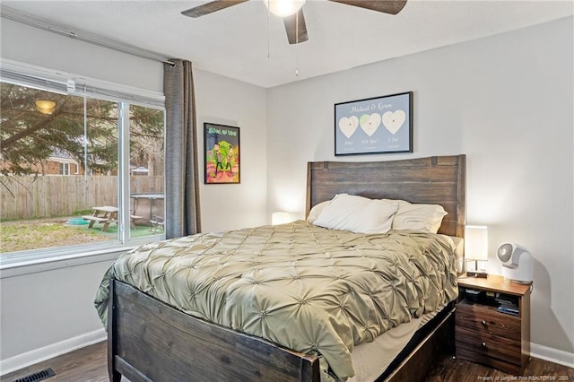 bedroom featuring visible vents, baseboards, wood finished floors, and a ceiling fan