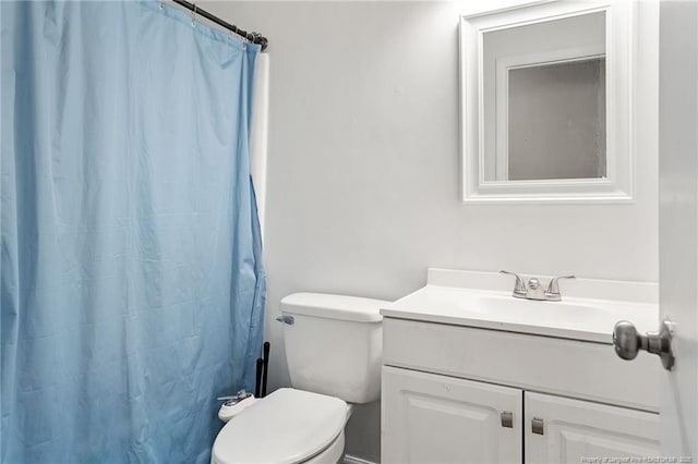 bathroom with vanity, a shower with shower curtain, and toilet