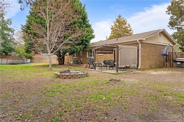 view of yard with a patio, an outdoor fire pit, and fence