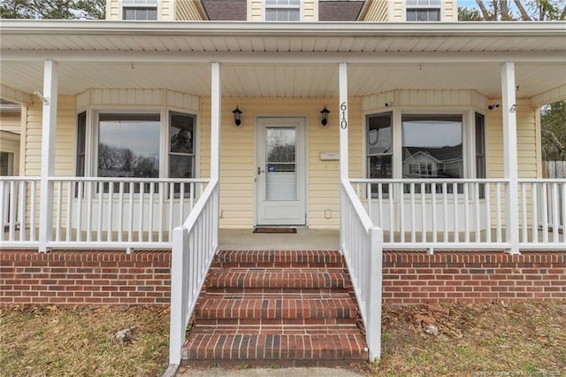 view of exterior entry with covered porch