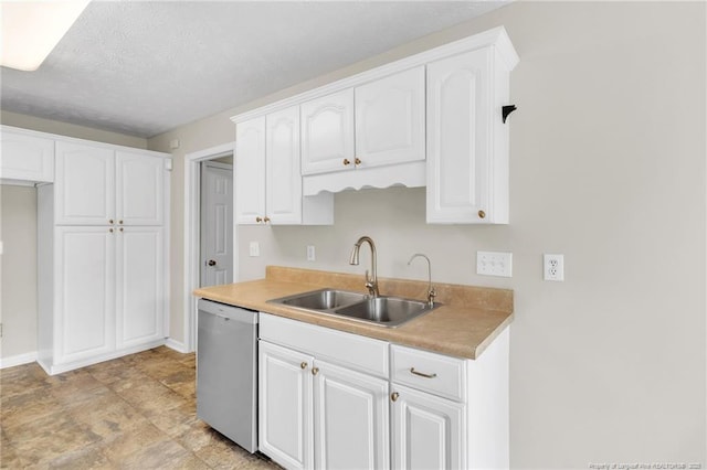 kitchen with a sink, stainless steel dishwasher, white cabinets, and light countertops