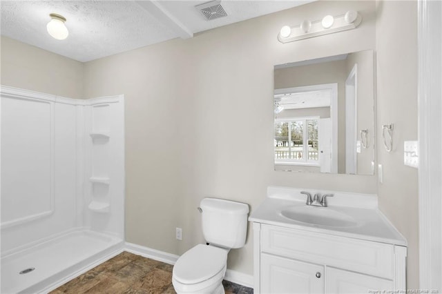 bathroom with visible vents, toilet, walk in shower, and vanity