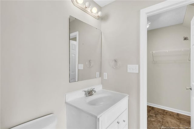 bathroom featuring vanity and baseboards