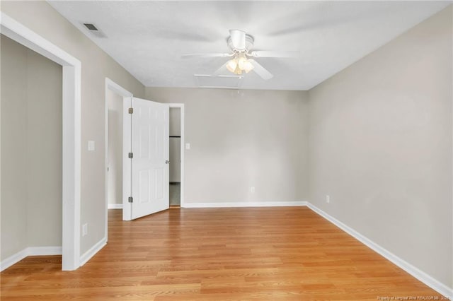 unfurnished bedroom with visible vents, baseboards, light wood-style flooring, and a ceiling fan