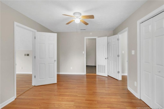 unfurnished bedroom with light wood-style flooring, visible vents, baseboards, and ceiling fan