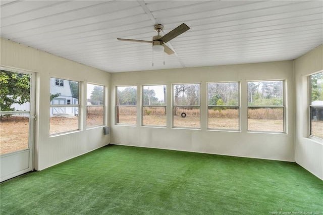 unfurnished sunroom featuring a healthy amount of sunlight and ceiling fan