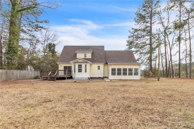 back of house with a wooden deck and fence