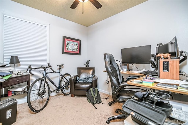 carpeted office with baseboards, a textured ceiling, and a ceiling fan