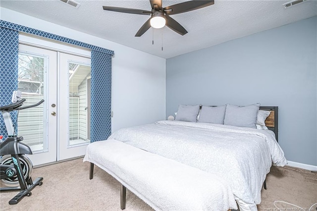 carpeted bedroom with french doors, a textured ceiling, visible vents, and access to outside