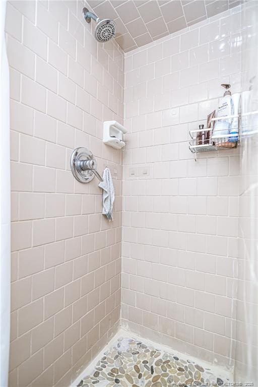 bathroom with a tile shower