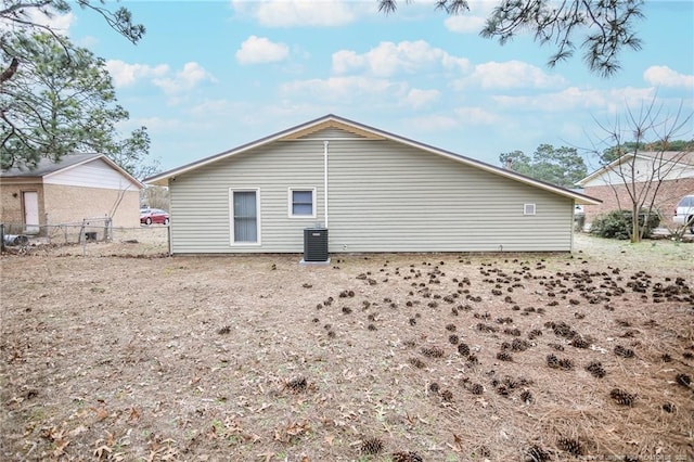 back of property with cooling unit and fence