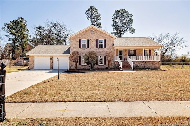 split level home with an attached garage, a porch, concrete driveway, and a front lawn