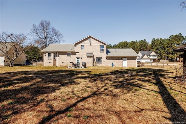 back of property featuring a yard and fence