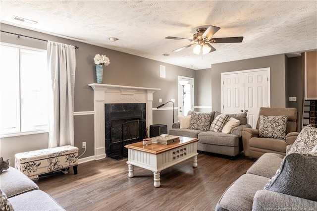 living room with ceiling fan, a healthy amount of sunlight, and wood finished floors