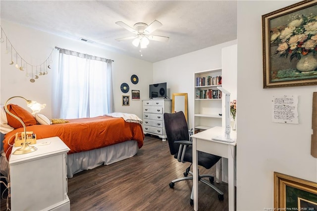 bedroom with dark wood-type flooring, a ceiling fan, and visible vents