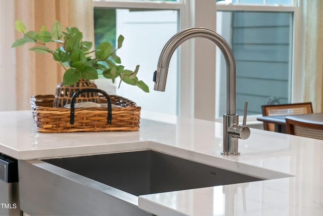 room details featuring light countertops and a sink