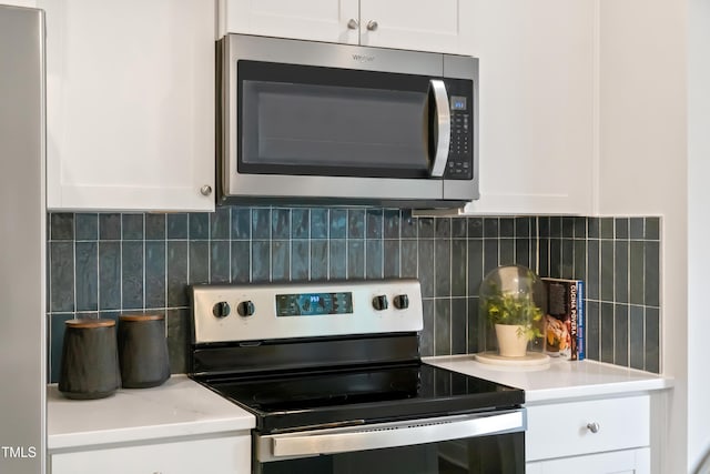 kitchen featuring white cabinetry, decorative backsplash, light countertops, and stainless steel appliances