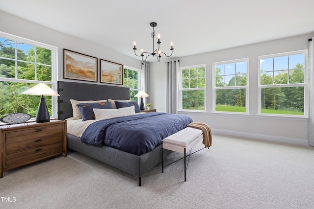 bedroom featuring a notable chandelier, baseboards, and carpet floors