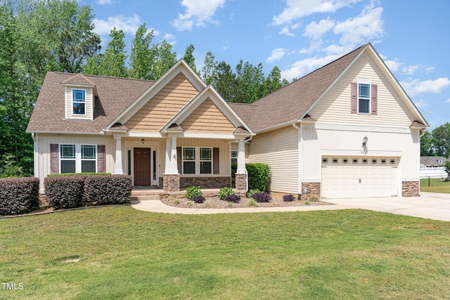 view of front of property featuring a porch, a garage, a front lawn, concrete driveway, and stone siding