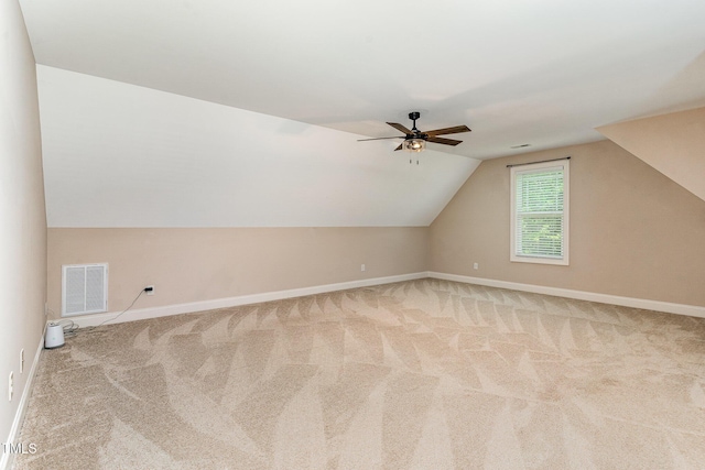 additional living space with ceiling fan, visible vents, carpet floors, baseboards, and lofted ceiling