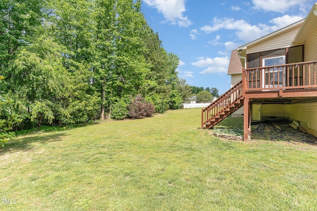 view of yard featuring stairs, a sunroom, and a deck