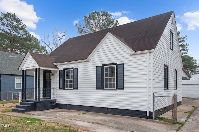 view of front of house with crawl space, a shingled roof, an outdoor structure, and fence