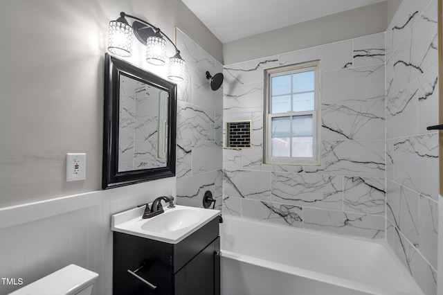 bathroom featuring vanity, toilet, and washtub / shower combination