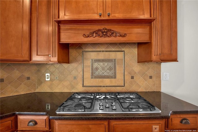 kitchen with decorative backsplash, brown cabinetry, and stainless steel gas cooktop