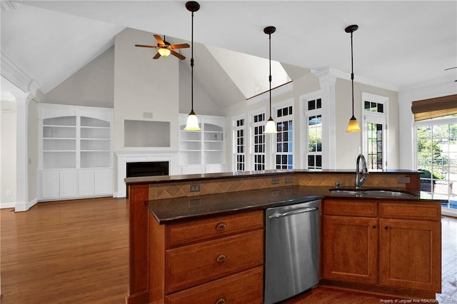 kitchen with open floor plan, brown cabinets, stainless steel dishwasher, a ceiling fan, and a sink