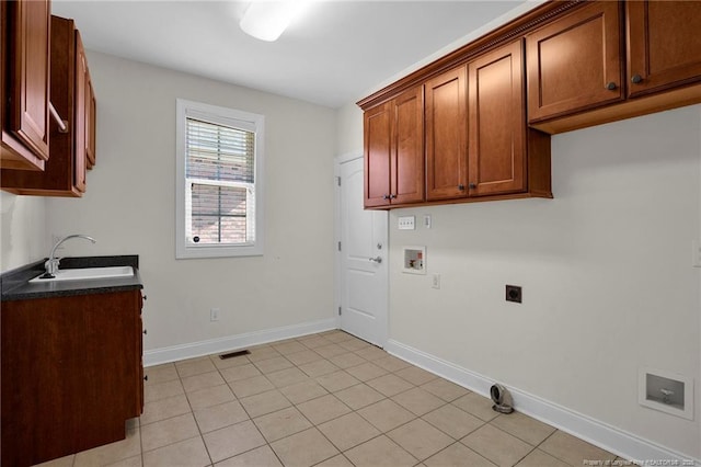 clothes washing area featuring visible vents, hookup for a washing machine, cabinet space, hookup for an electric dryer, and a sink