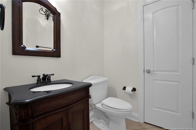 bathroom featuring tile patterned flooring, toilet, and vanity