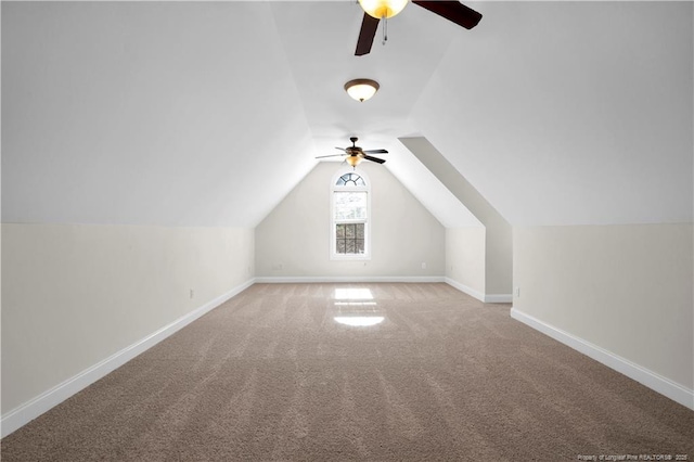 additional living space featuring baseboards, lofted ceiling, a ceiling fan, and light carpet