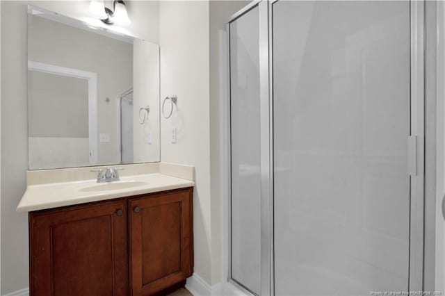 full bathroom featuring a stall shower and vanity