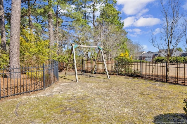 view of yard featuring a playground and fence