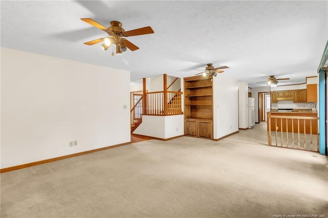 unfurnished living room featuring light carpet, baseboards, and ceiling fan