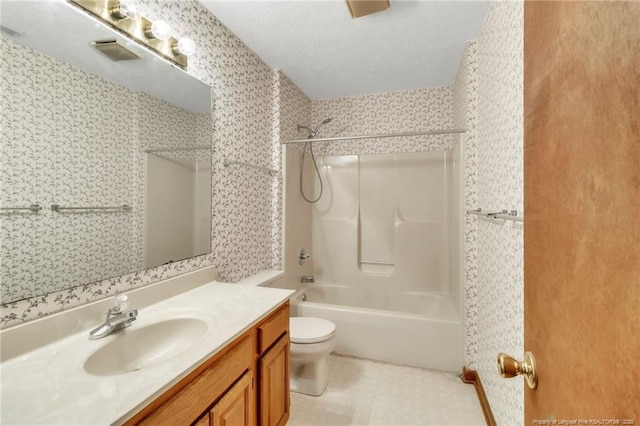 bathroom with wallpapered walls, toilet, shower / bath combination, a textured ceiling, and vanity