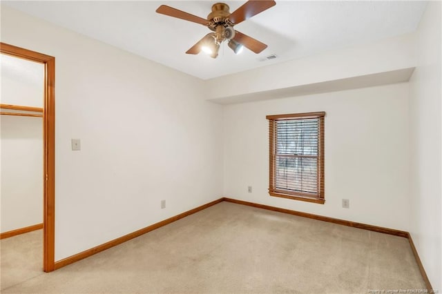 unfurnished bedroom with visible vents, baseboards, ceiling fan, light colored carpet, and a closet