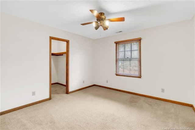 unfurnished room with visible vents, baseboards, ceiling fan, and carpet floors