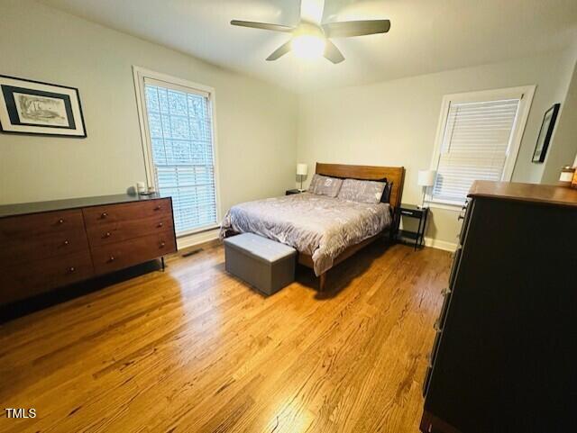 bedroom with baseboards, a ceiling fan, and wood finished floors