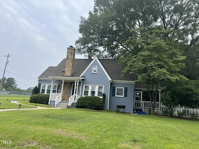 bungalow featuring fence, a chimney, a front lawn, and a shingled roof