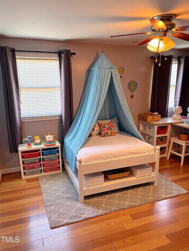 bedroom with light wood-type flooring and a ceiling fan
